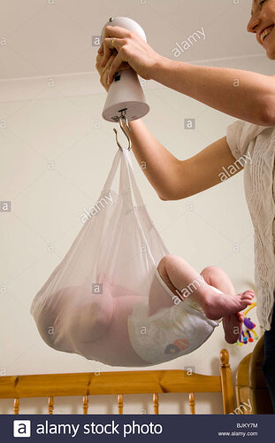 weighing-a-newborn-new-born-baby-with-scales-weight-scale-BJKY7M