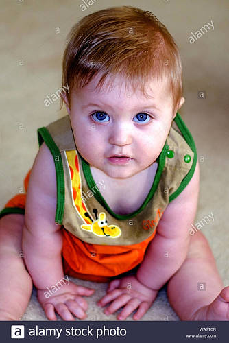 sweet-baby-boy-with-big-blue-eyes-looking-up-at-the-camera-WA7T0R